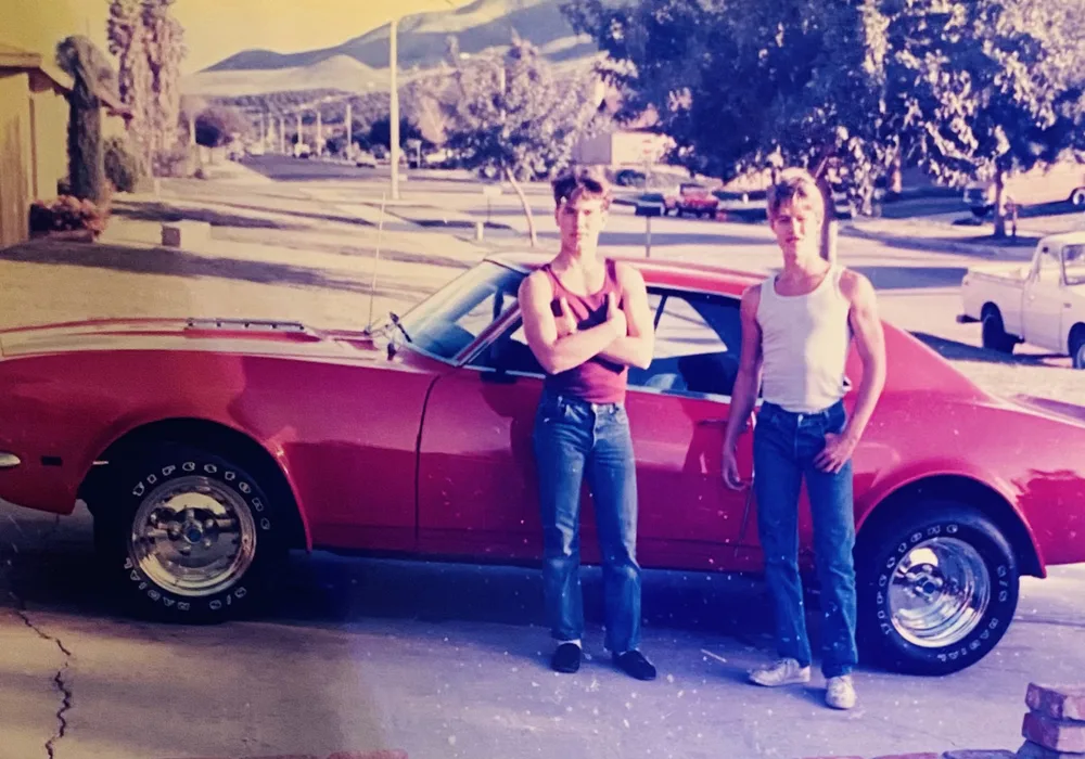 Nick Muratore, right, and his best friend Mike in front of Nick's red 1968 Camaro, 1985